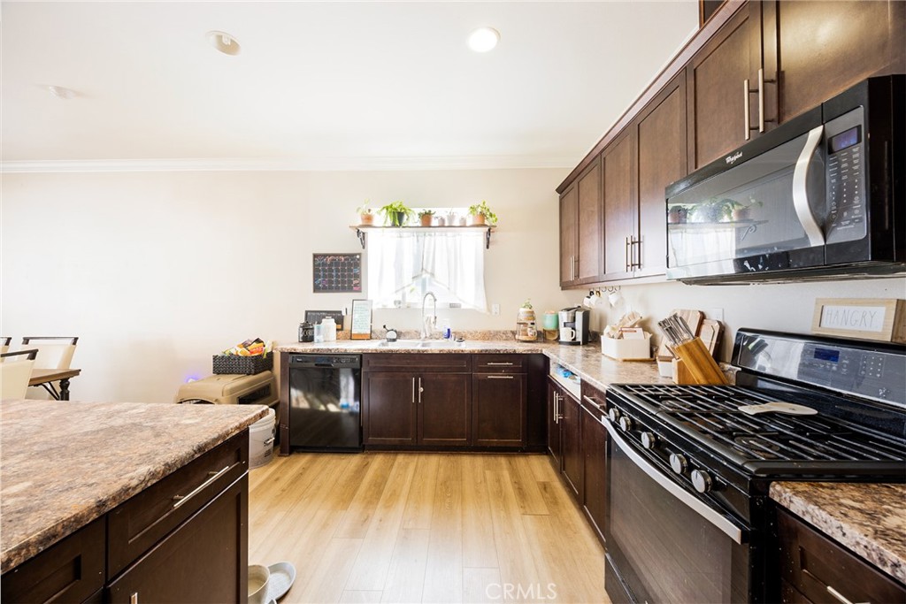 20668 Pitchfork Drive Riverside, CA 92507 - Photo 12 of 25 a kitchen with sink stove and cabinets