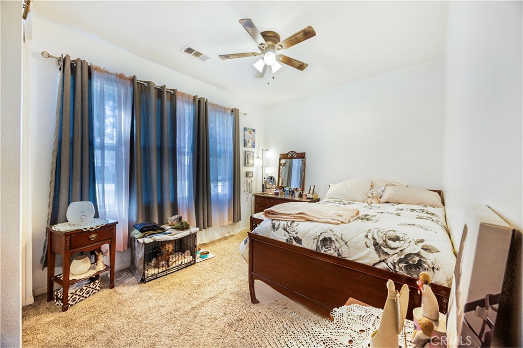 20668 Pitchfork Drive Riverside, CA 92507 - Photo 15 of 25 a bed sitting in a bedroom next to a window