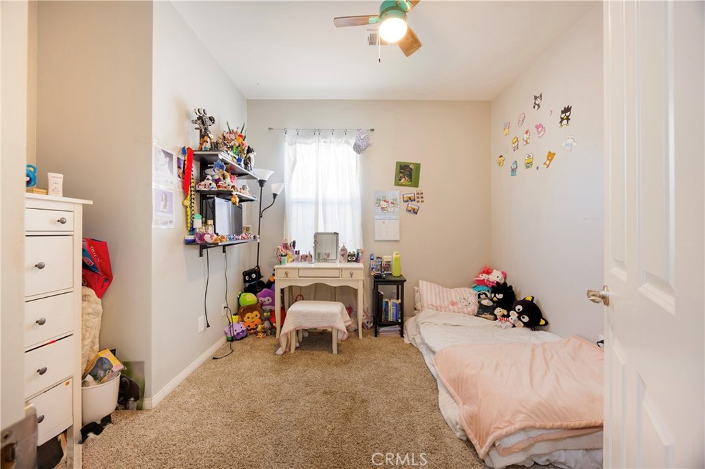 20668 Pitchfork Drive Riverside, CA 92507 - Photo 19 of 25 a room with a baby bed baby crib and a dresser