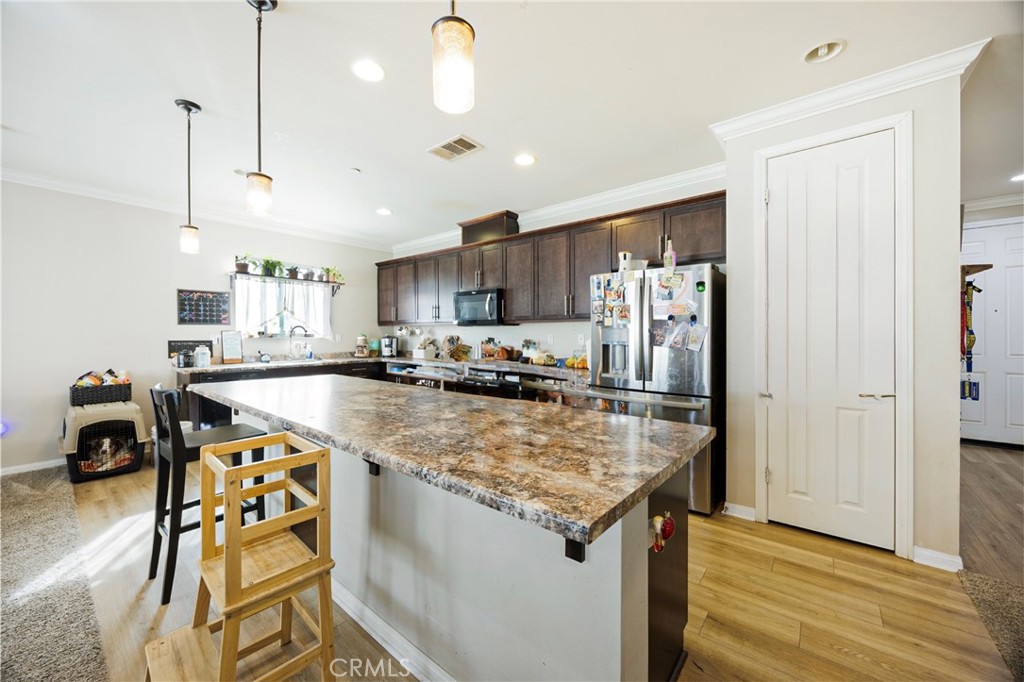 20668 Pitchfork Drive Riverside, CA 92507 - Photo 10 of 25 a kitchen with stainless steel appliances granite countertop a refrigerator stove microwave and cabinets