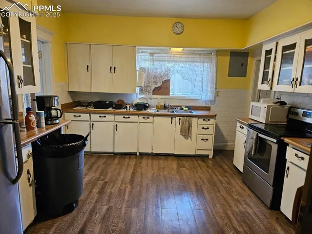 a kitchen with stainless steel appliances a stove top oven and a refrigerator