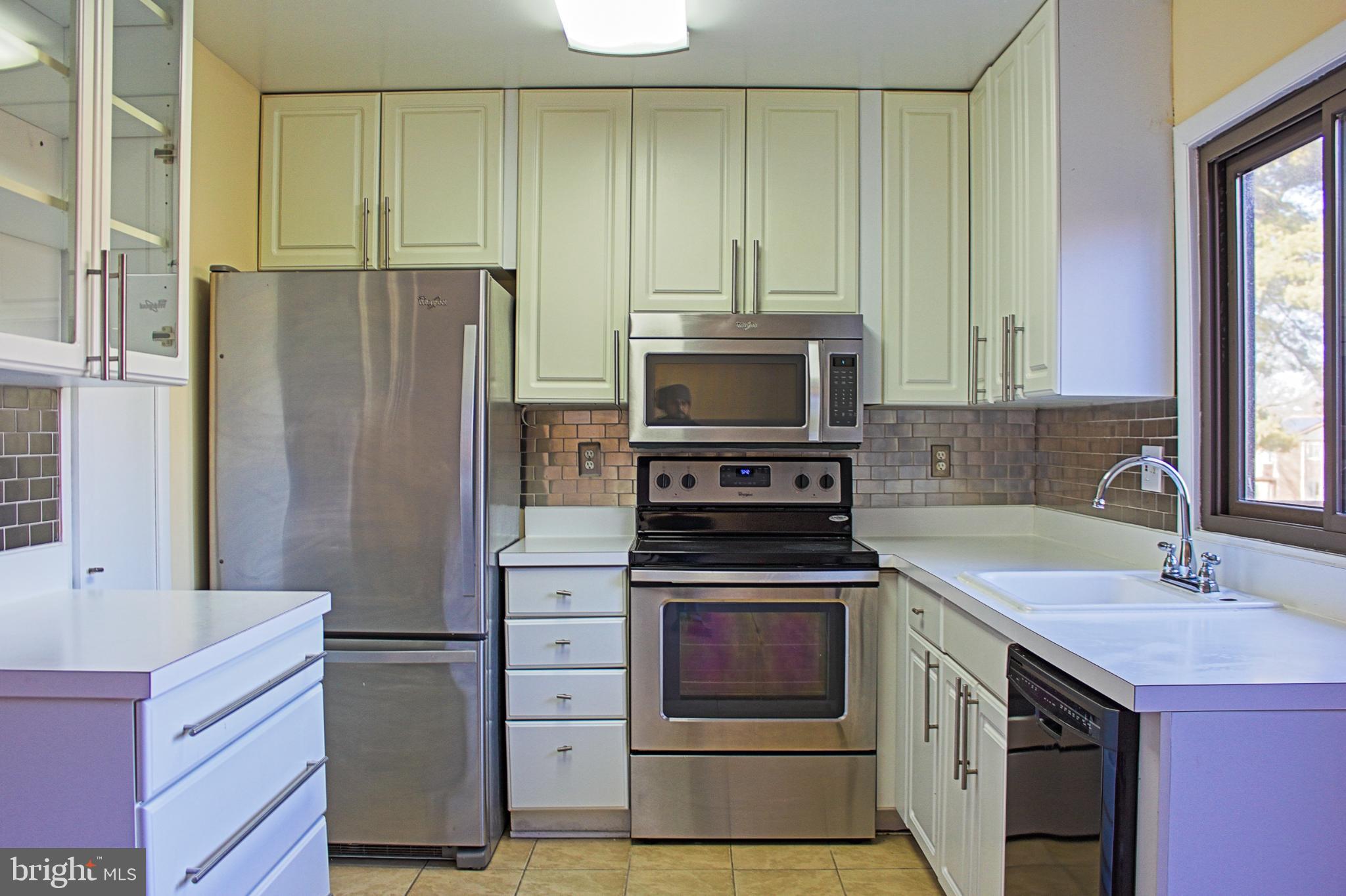 9040 Centerway Road Gaithersburg, MD 20879 - Photo 19 of 43 Modern kitchen with stainless steel appliances.