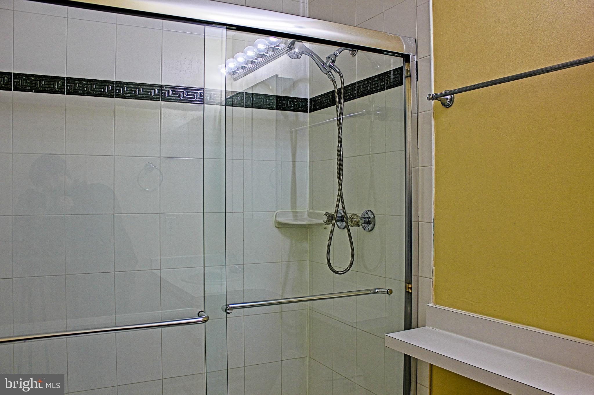 9040 Centerway Road Gaithersburg, MD 20879 - Photo 38 of 43 Modern glass shower within the main bedroom.