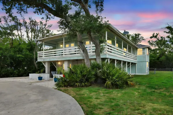 a front view of a house with yard and green space