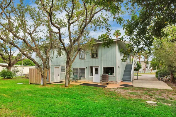 a kitchen with stainless steel appliances granite countertop a refrigerator a stove a kitchen island with a dining table and chairs