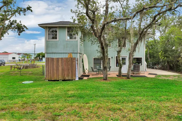 a large kitchen with lots of counter space a sink a window and stainless steel appliances