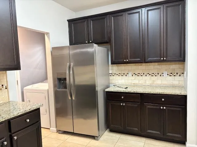 a kitchen with a refrigerator and cabinets