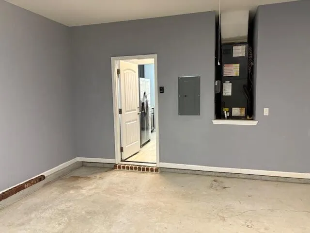 a view of an empty room with wooden floor and entryway