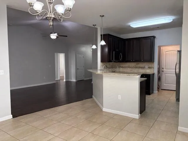 a kitchen with kitchen island a counter top space appliances and cabinets