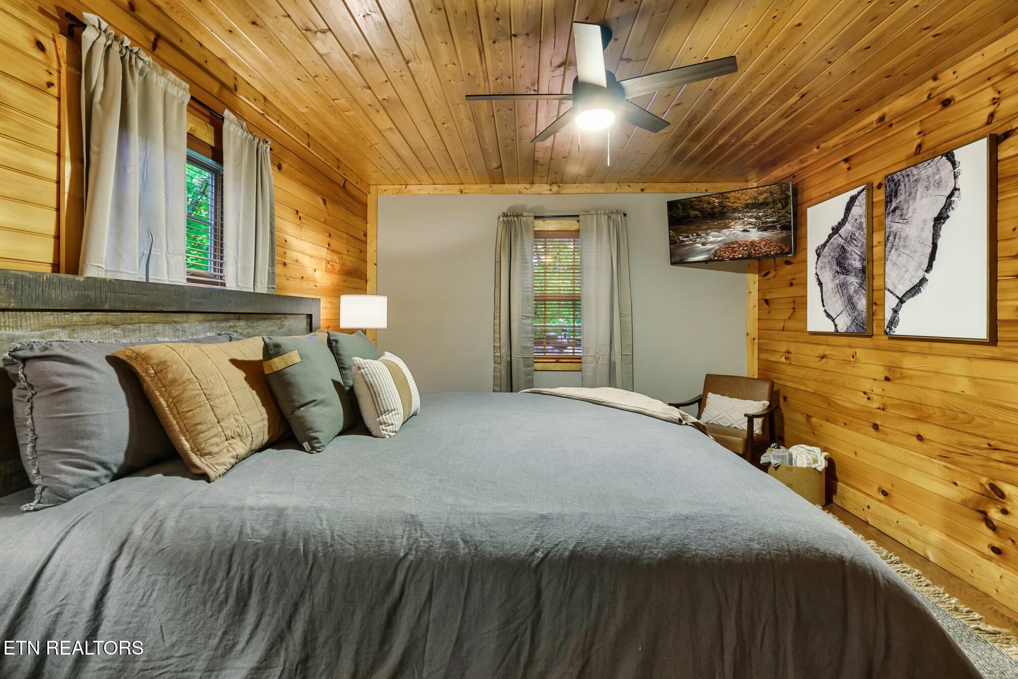 3330 Robeson Road Sevierville, TN 37862 - Photo 13 of 42 a bedroom with a large bed and a chandelier