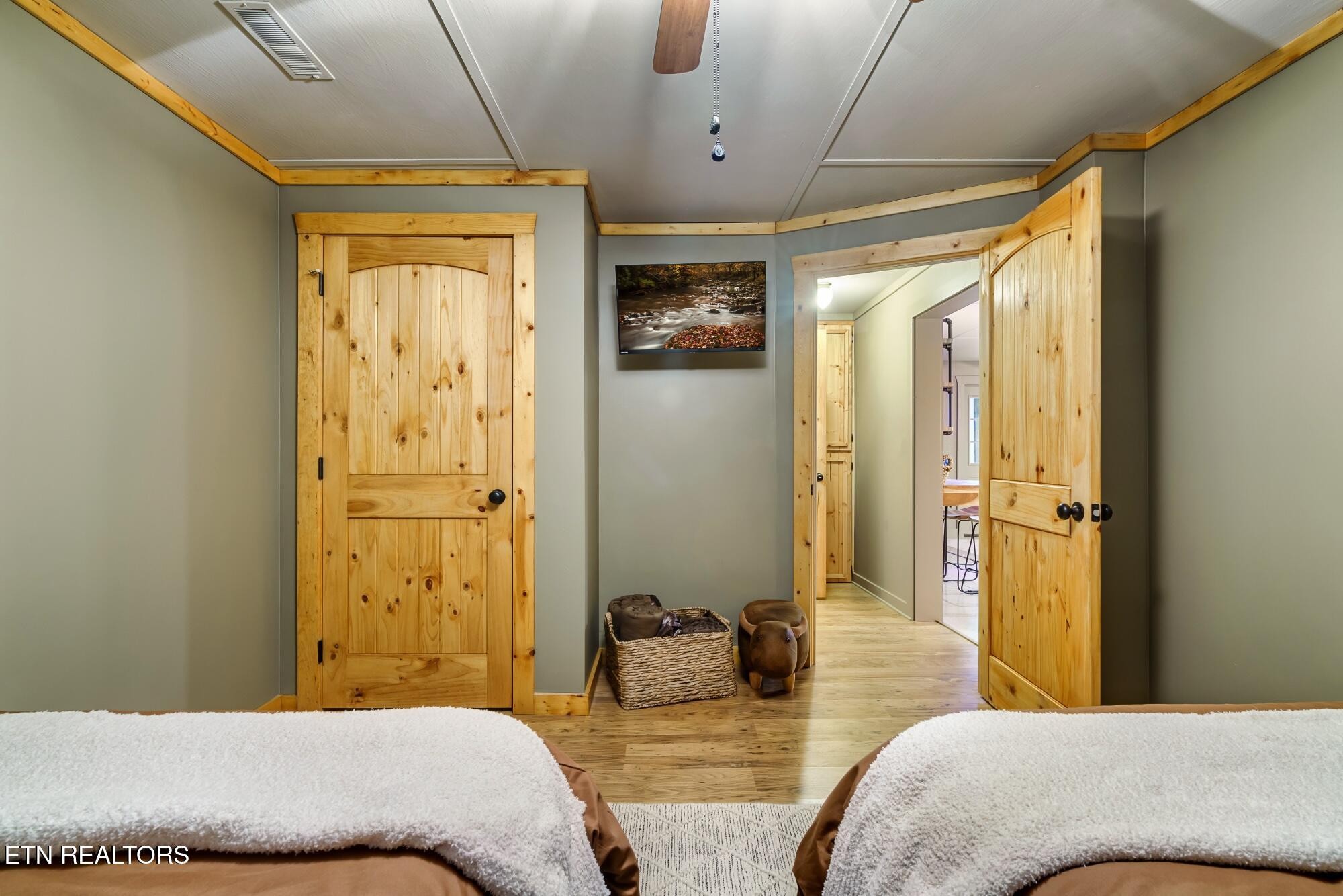 3330 Robeson Road Sevierville, TN 37862 - Photo 21 of 42 a bedroom with a large bed and a chandelier