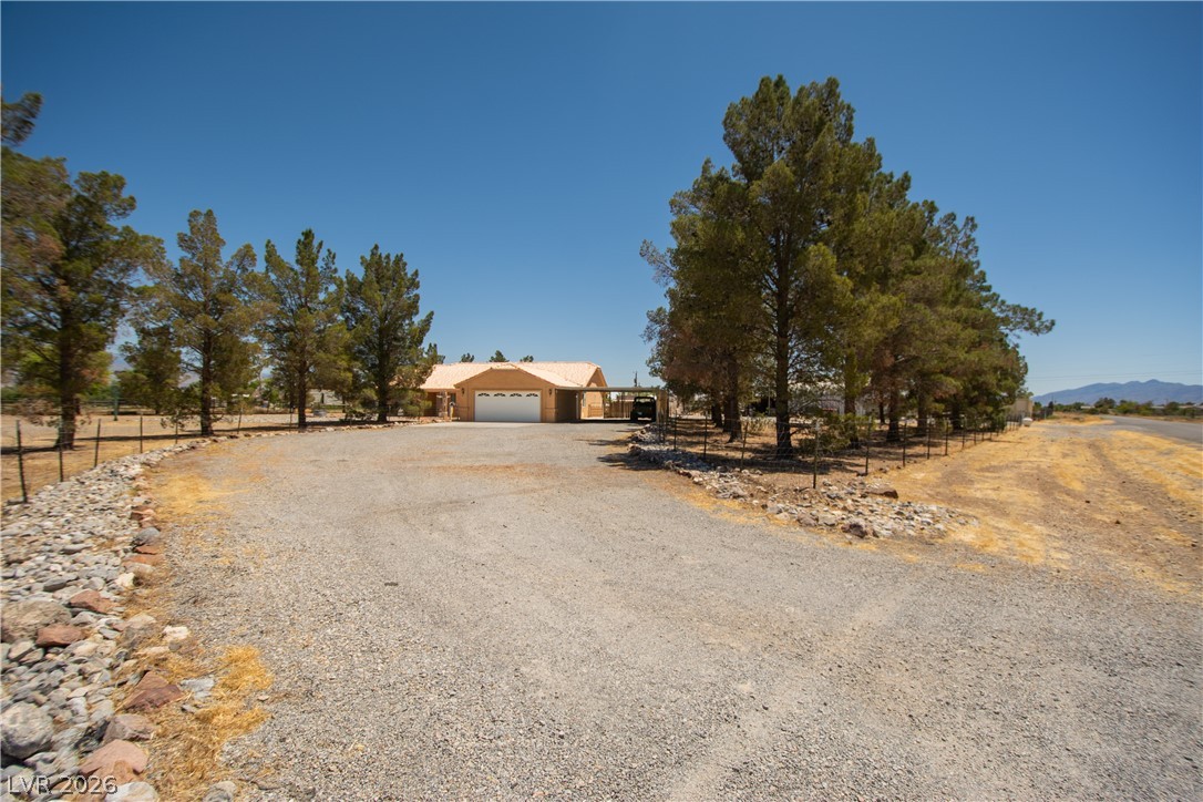 2381 Tough Boy Road Pahrump, NV 89060 - Photo 2 of 44 This desert dwelling offers spacious grounds and abundant parking, blending comfort with convenience.
