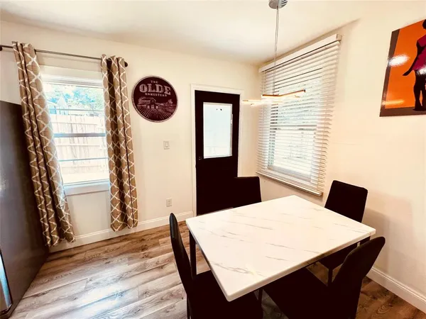 a kitchen with a table chairs and a refrigerator