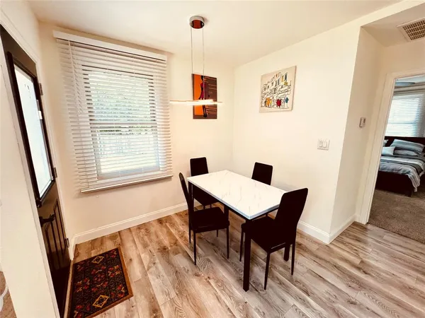 a view of a dining room with furniture window and wooden floor