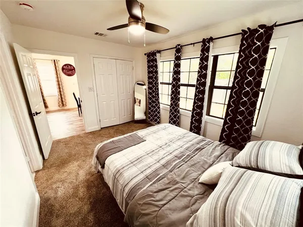 a bedroom with a bed and a large mirror
