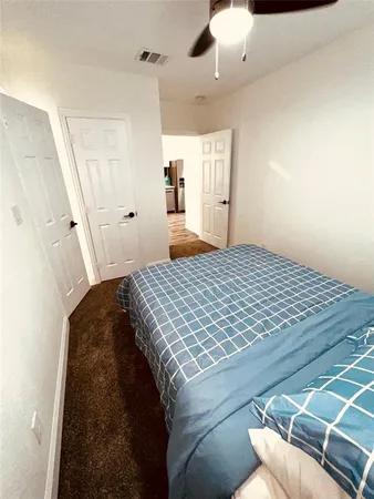 a bedroom with a bed and cabinets