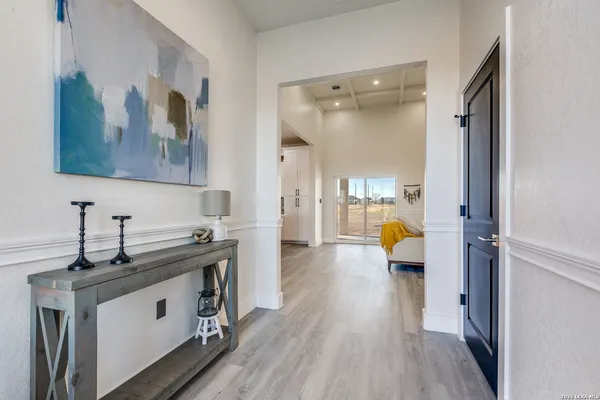 a view of living room with furniture and wooden floor