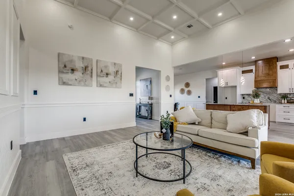 a living room with furniture and kitchen view