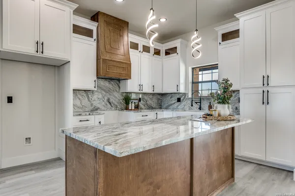a kitchen with stainless steel appliances granite countertop a sink a oven and a refrigerator