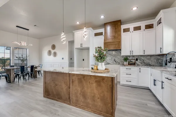 a large kitchen with stainless steel appliances kitchen island granite countertop a large island in the center