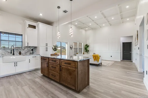 a kitchen with a sink stove and cabinets