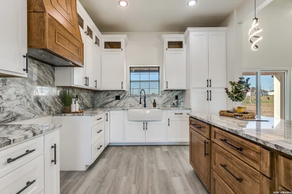 a kitchen with granite countertop a sink and a stove