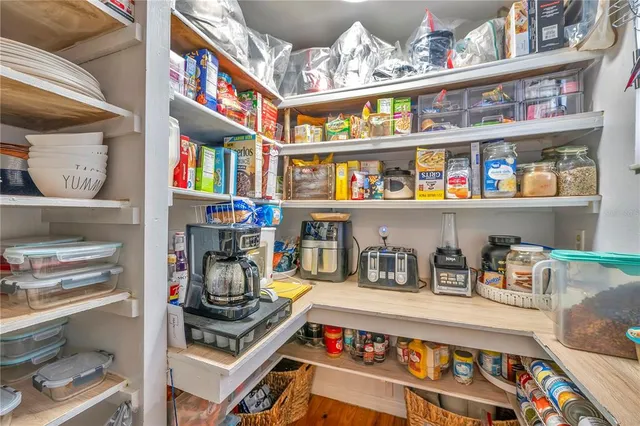 a living room with stainless steel appliances kitchen island granite countertop a kitchen view and living room with a couch