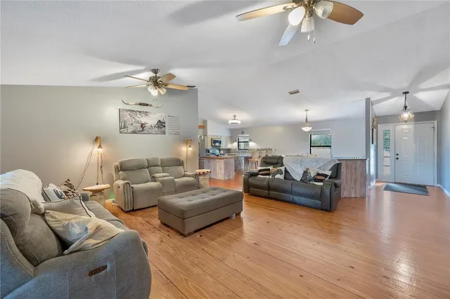 a view of a livingroom with furniture and a ceiling fan