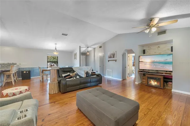 a front view of a house with a yard and potted plants