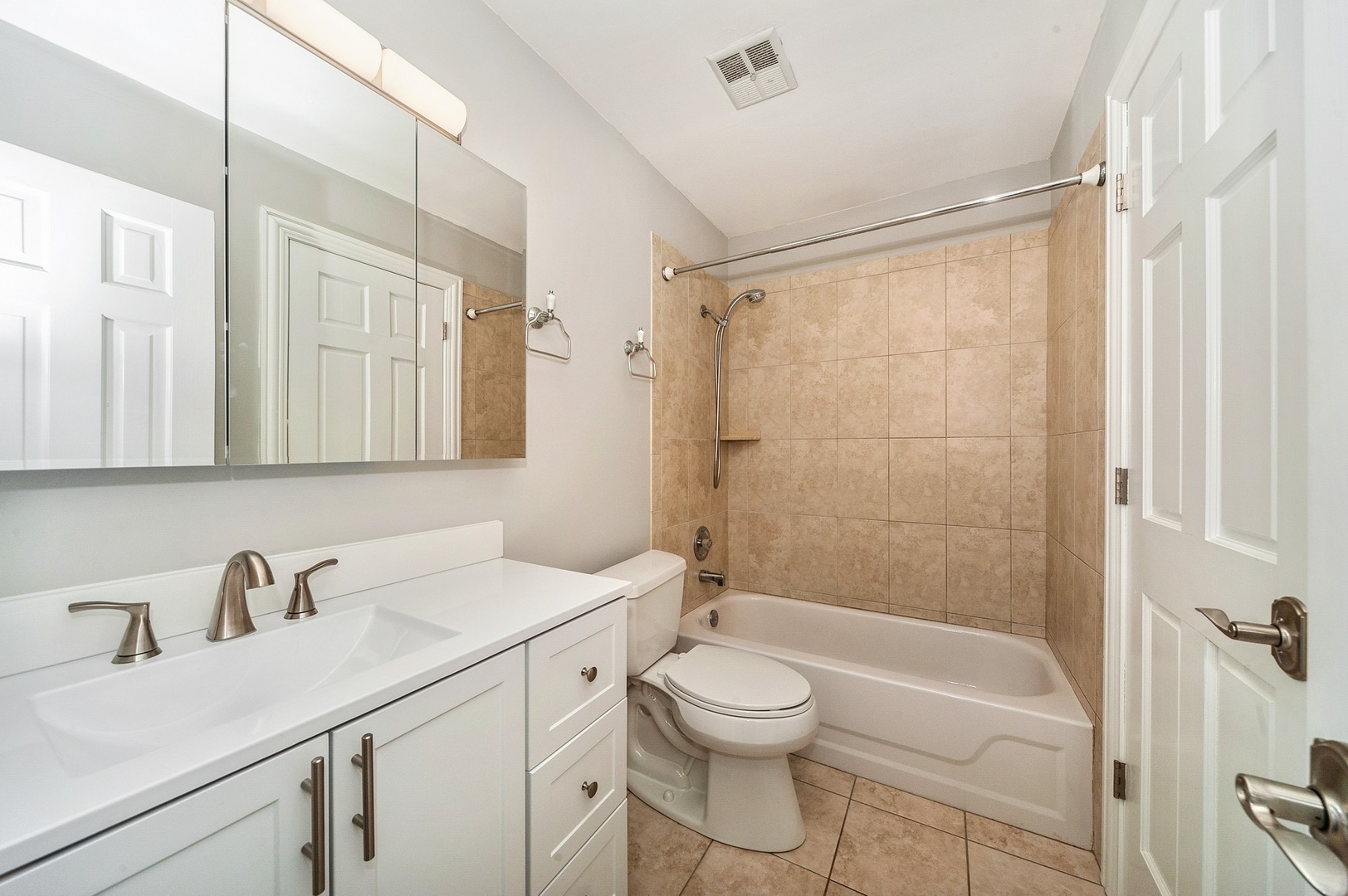 608 Inverrary Lane, Unit 608 Deerfield, IL 60015 - Photo 15 of 20 a bathroom with a sink a toilet a mirror and shower