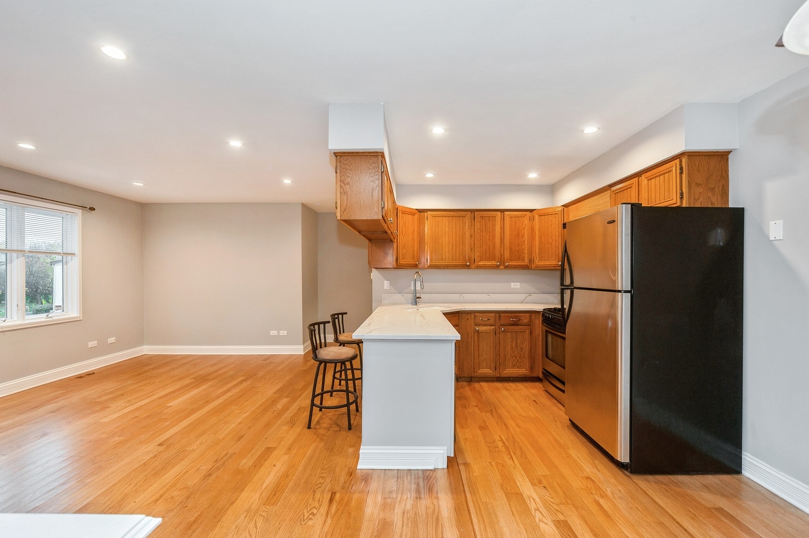 608 Inverrary Lane, Unit 608 Deerfield, IL 60015 - Photo 5 of 20 a kitchen with stainless steel appliances a refrigerator a stove top oven and wooden floors
