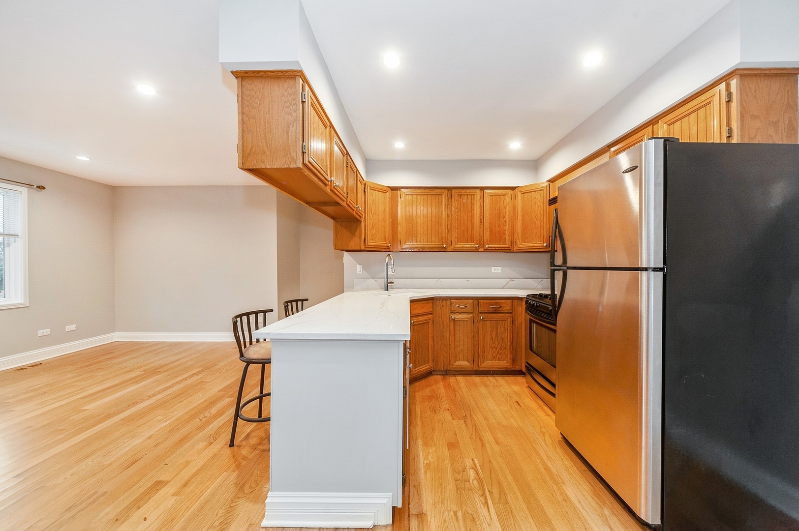 608 Inverrary Lane, Unit 608 Deerfield, IL 60015 - Photo 6 of 20 a view of a kitchen with a fridge and wooden floor