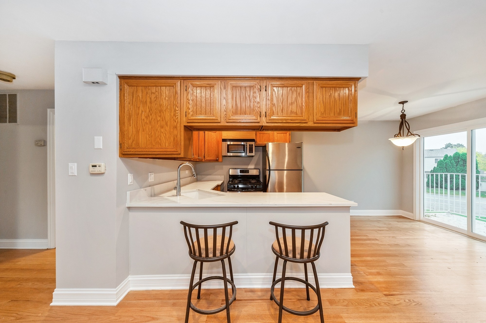 608 Inverrary Lane, Unit 608 Deerfield, IL 60015 - Photo 10 of 20 a kitchen with a table chairs and a wooden floor