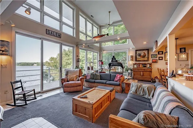a living room with furniture a large window and a rug
