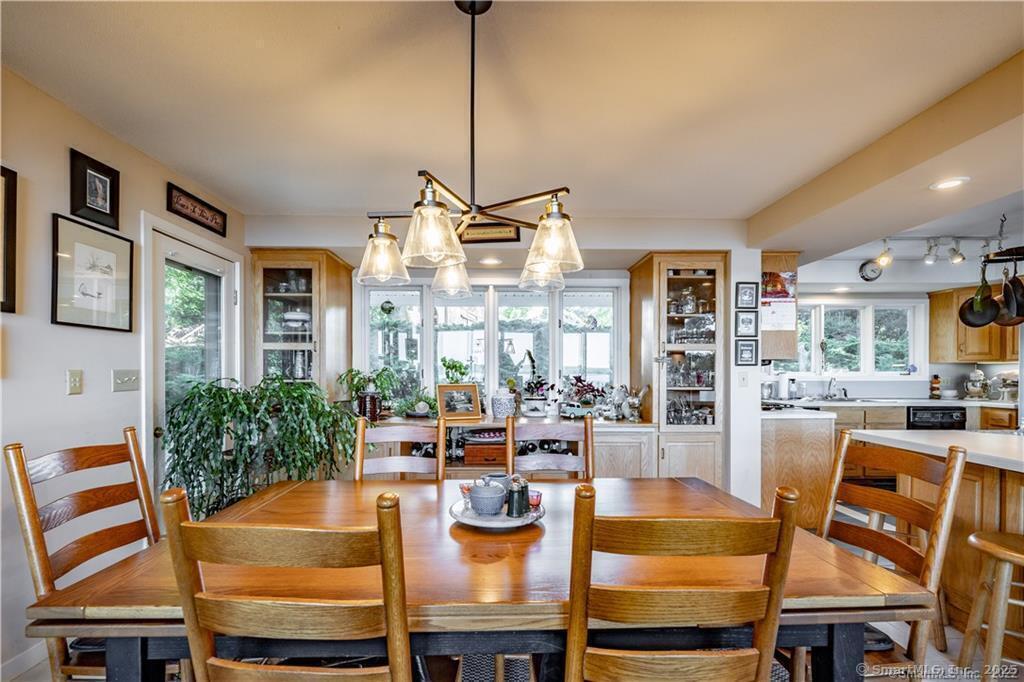 166 Old Colchester Road Salem, CT 06420 - Photo 10 of 13 a dining room with furniture a chandelier and wooden floor