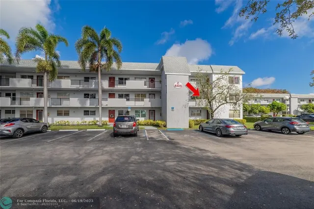 a view of a cars park in front of a building