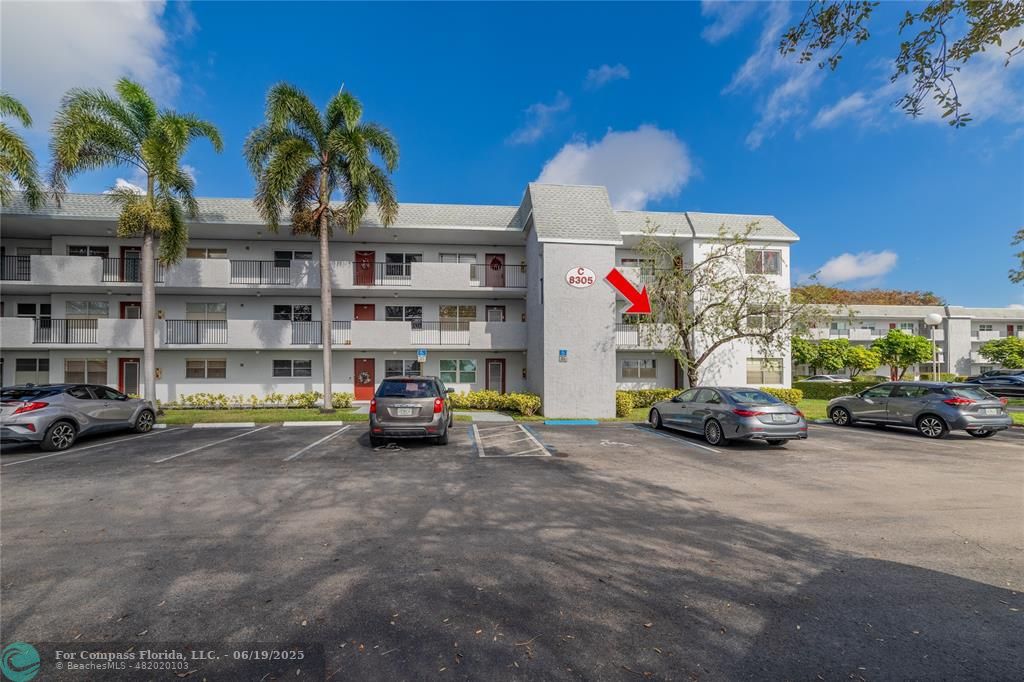 a view of a cars park in front of a building