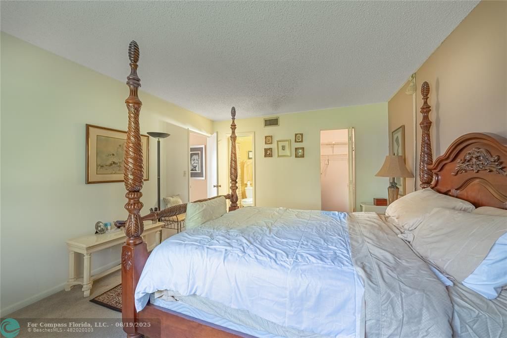 8305 Northwest 61st Street, Unit C215 Tamarac, FL 33321 - Photo 12 of 28 a bedroom with a bed and a dresser