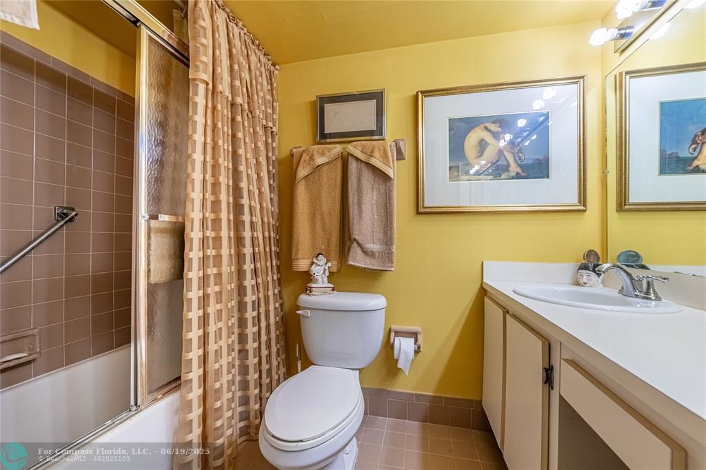 8305 Northwest 61st Street, Unit C215 Tamarac, FL 33321 - Photo 14 of 28 a bathroom with a toilet sink and mirror