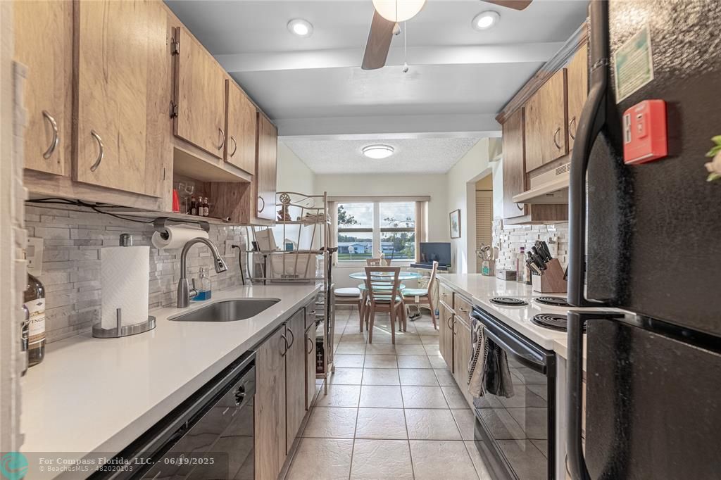 8305 Northwest 61st Street, Unit C215 Tamarac, FL 33321 - Photo 19 of 28 a kitchen with lots of counter top space