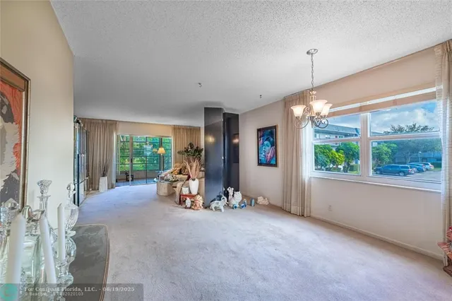 a living room with furniture and large windows