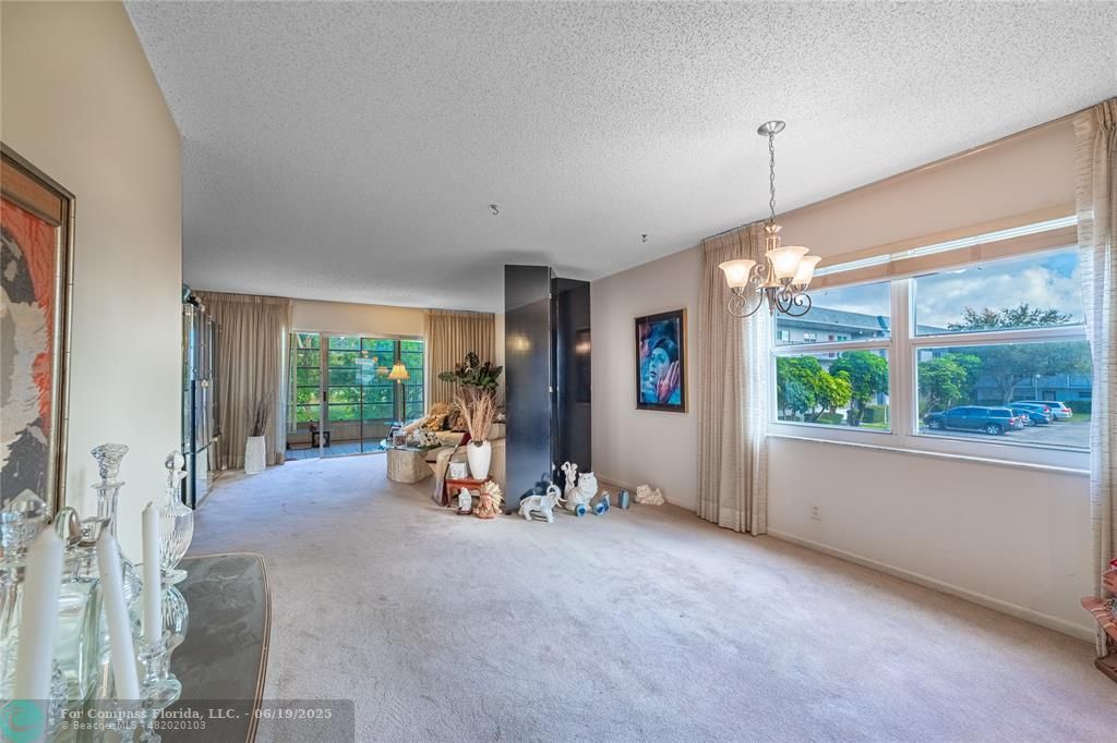 8305 Northwest 61st Street, Unit C215 Tamarac, FL 33321 - Photo 21 of 28 a view of a room with furniture and windows