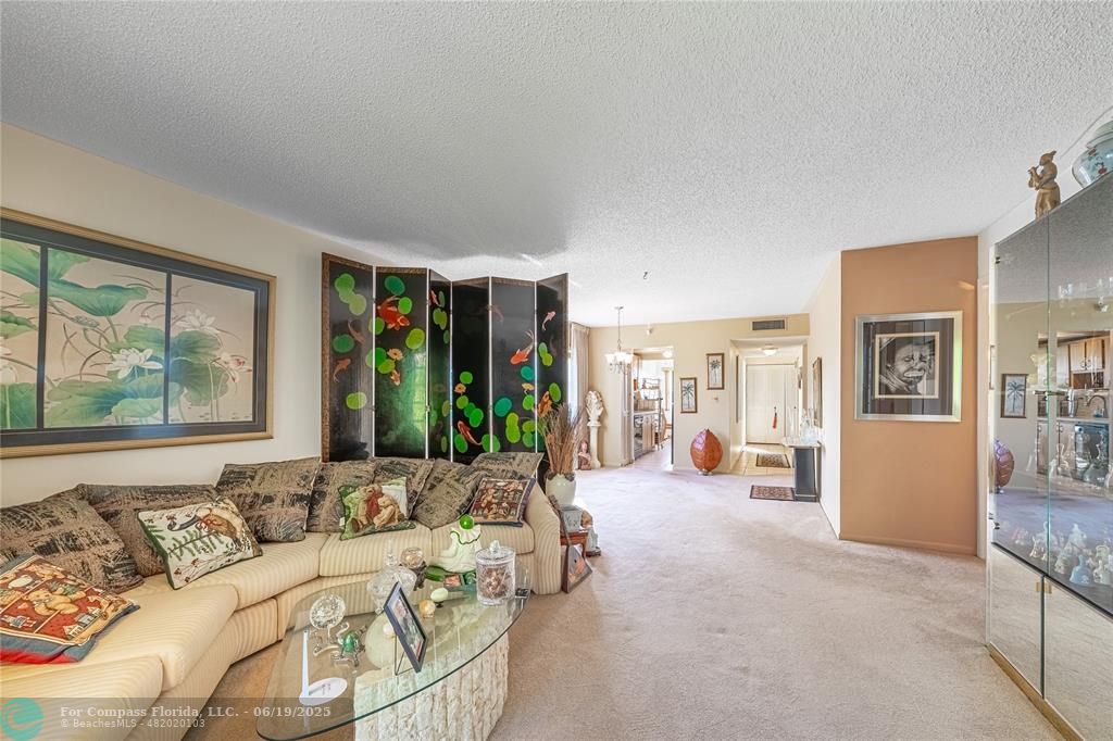 8305 Northwest 61st Street, Unit C215 Tamarac, FL 33321 - Photo 22 of 28 a living room with furniture and large windows