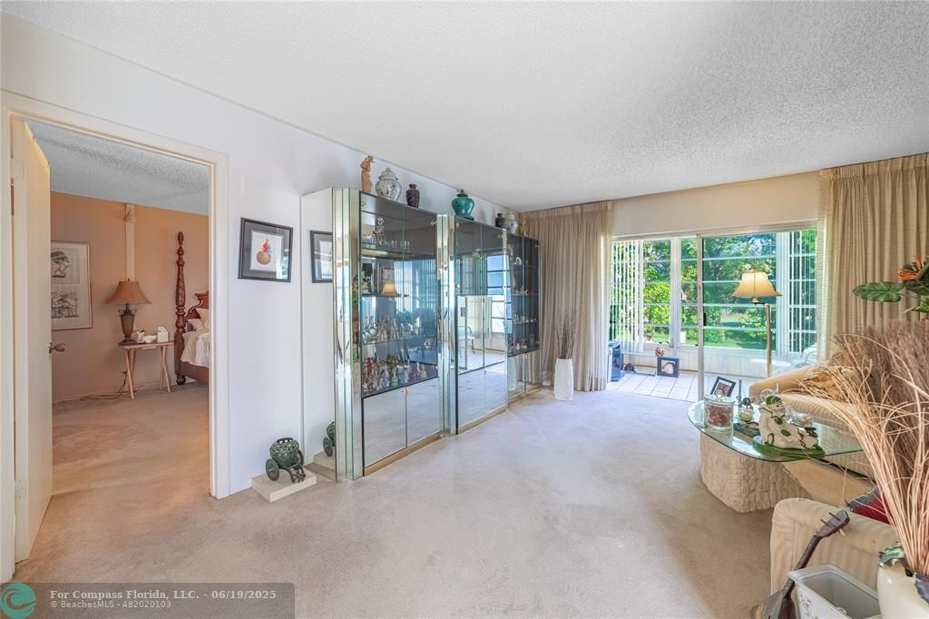 8305 Northwest 61st Street, Unit C215 Tamarac, FL 33321 - Photo 23 of 28 a spacious bedroom with a large bed and a large window