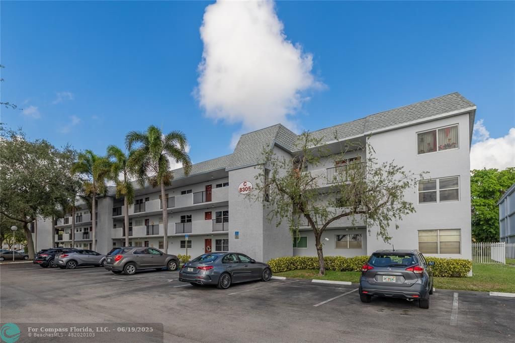 8305 Northwest 61st Street, Unit C215 Tamarac, FL 33321 - Photo 3 of 28 a car parked in front of a building