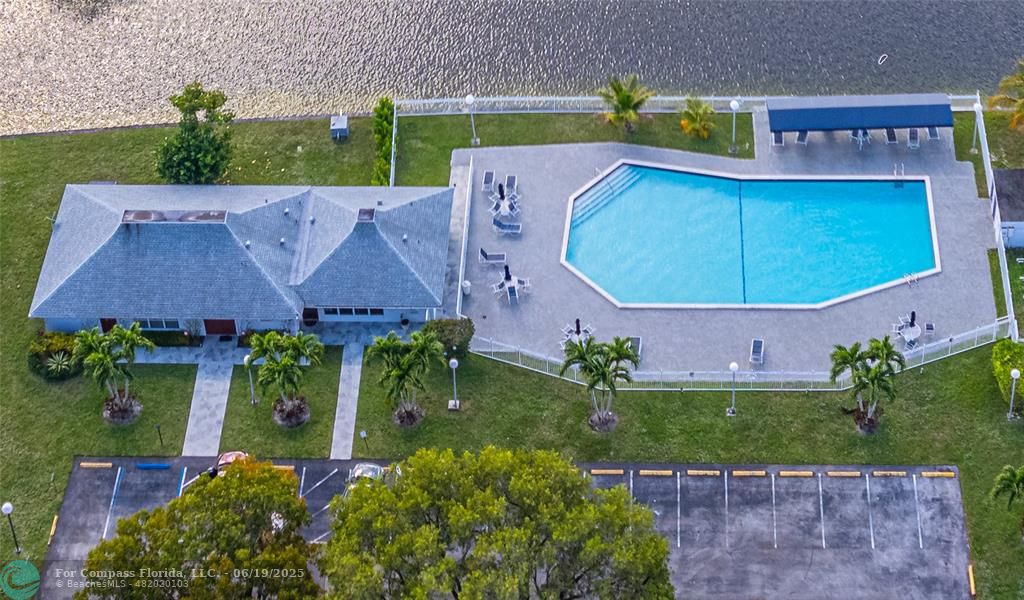 8305 Northwest 61st Street, Unit C215 Tamarac, FL 33321 - Photo 4 of 28 an aerial view of house with yard swimming pool and outdoor seating