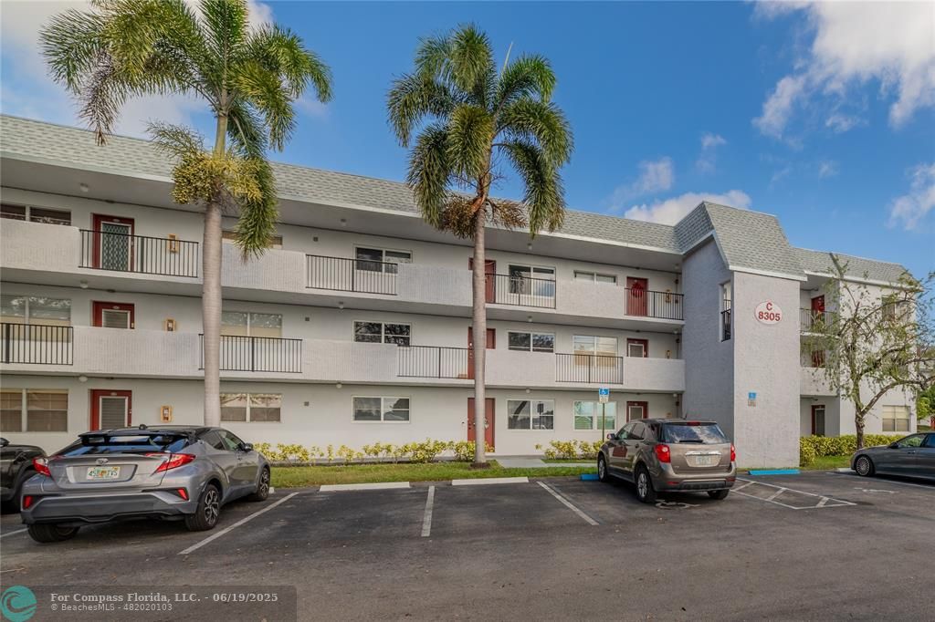 8305 Northwest 61st Street, Unit C215 Tamarac, FL 33321 - Photo 6 of 28 a car parked in front of a building