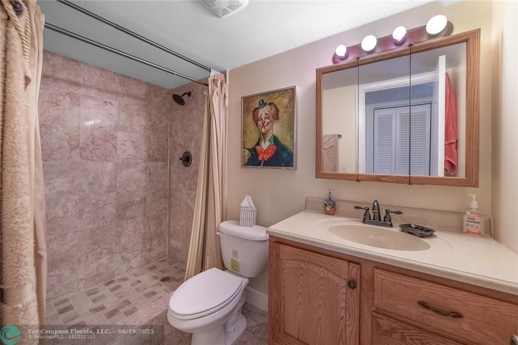 8305 Northwest 61st Street, Unit C215 Tamarac, FL 33321 - Photo 7 of 28 a bathroom with a sink a mirror a toilet and shower