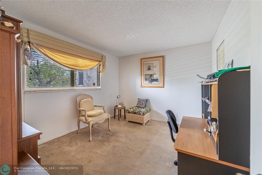 8305 Northwest 61st Street, Unit C215 Tamarac, FL 33321 - Photo 9 of 28 a living room with furniture and a window