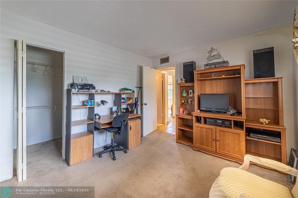 8305 Northwest 61st Street, Unit C215 Tamarac, FL 33321 - Photo 10 of 28 a work room with furniture and a flat screen tv